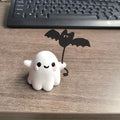 Mini ghost walking dog Halloween statue in resin, ghost holding bat design.