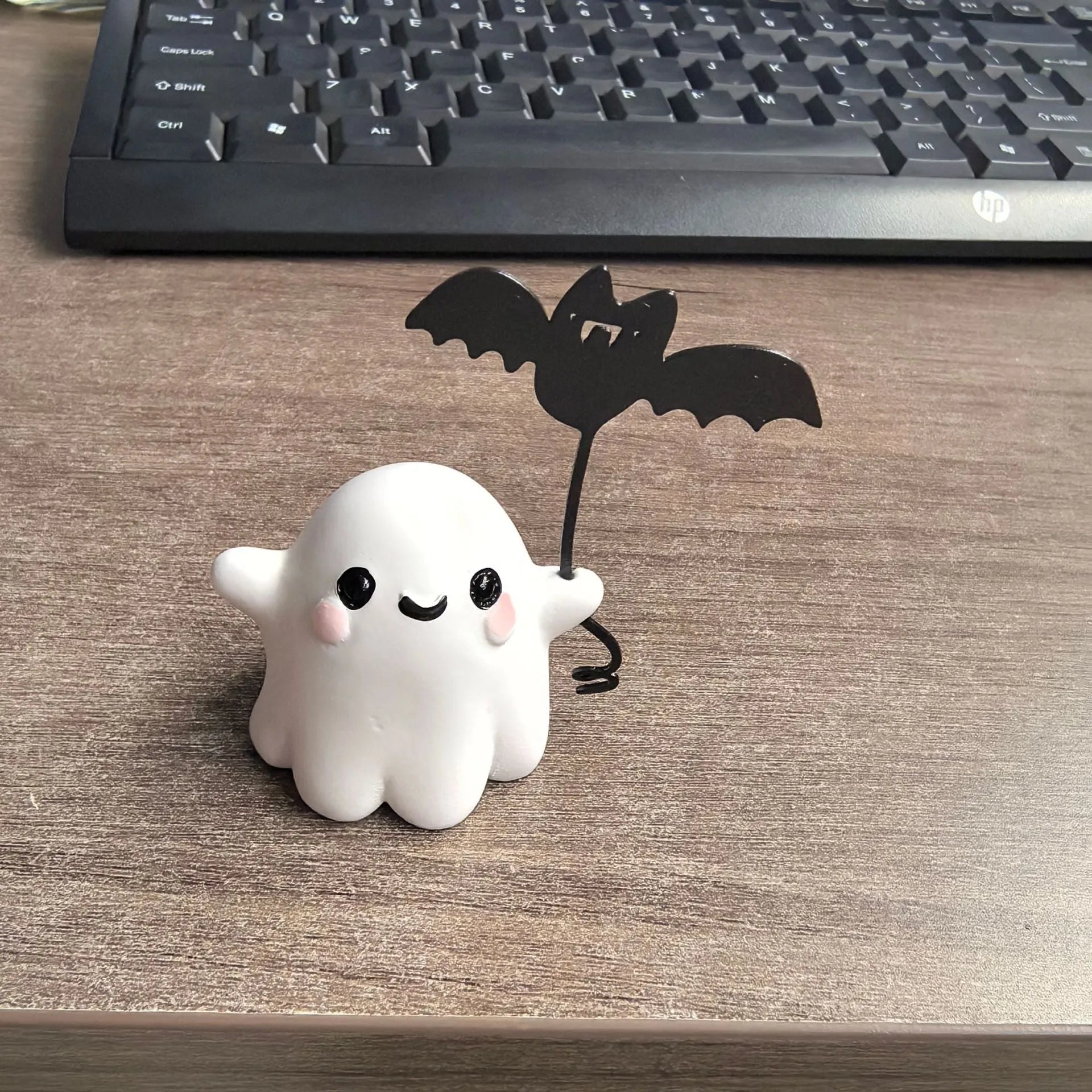 Mini ghost walking dog Halloween statue in resin, ghost holding bat design.