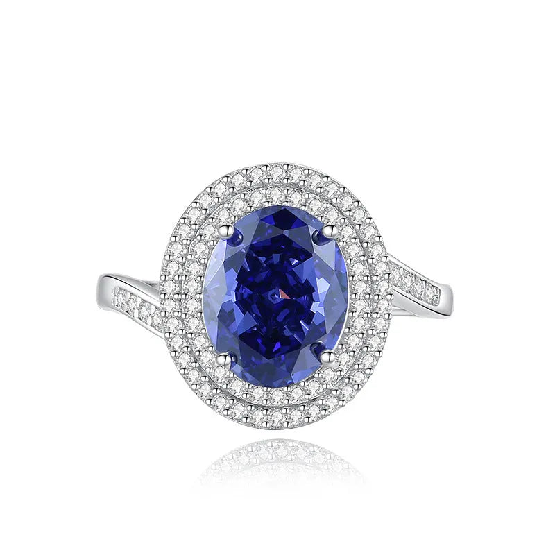 Heart shaped Tanzanite purple zircon ring in sterling silver on a grey background.