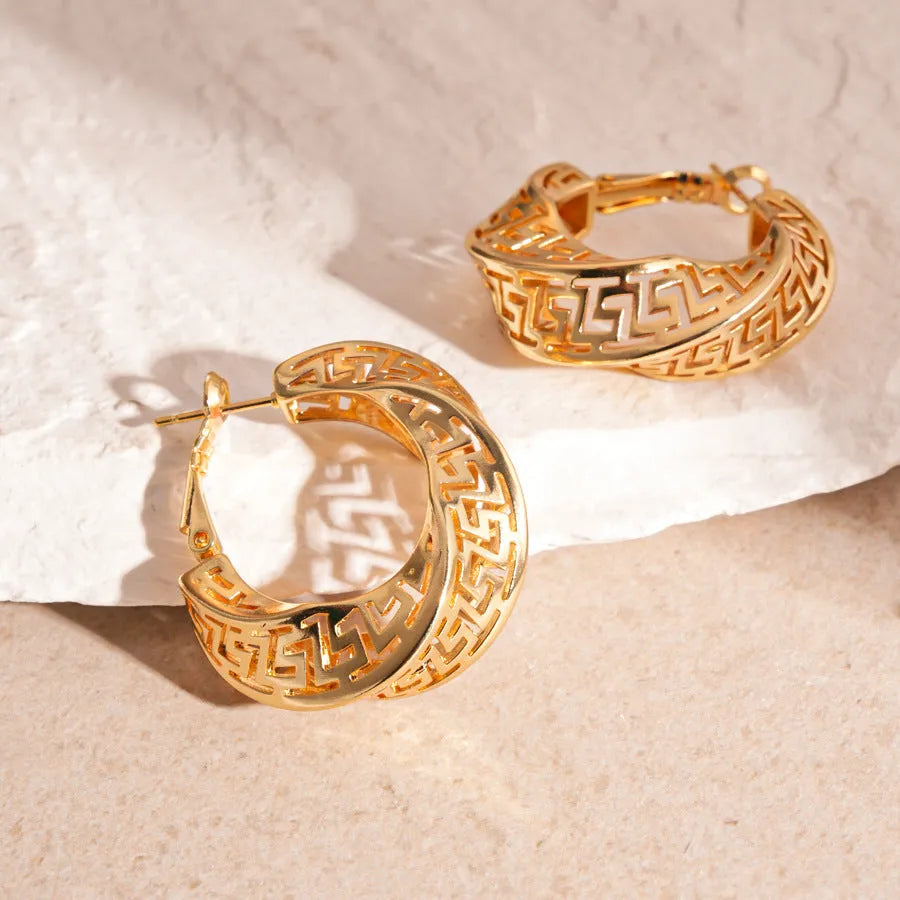 Twisted geometric hollow stud earrings in silver and gold electroplated finishes