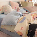 Cartoon dog pattern cotton bed sheet four-piece set shown on bed with matching pillowcases