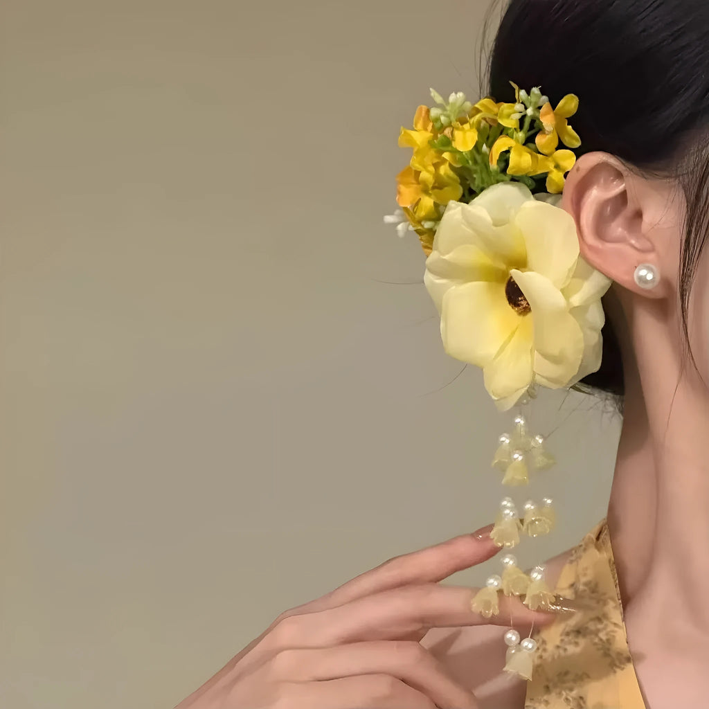Yellow flower tassel hairpin side clip accessory on display