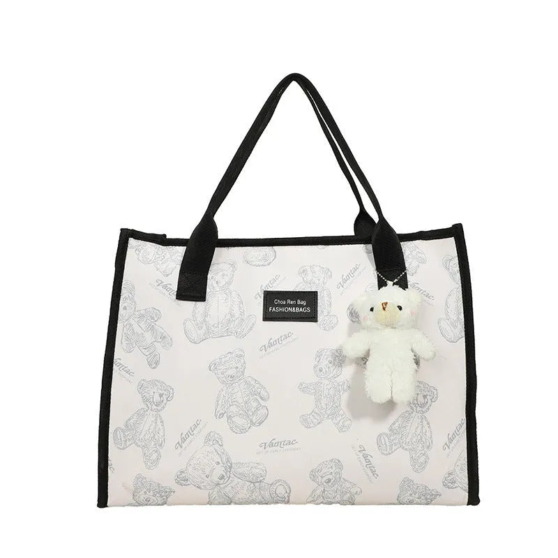Canvas tote bag with rhombus pattern design showing sandwich pocket and shoulder strap