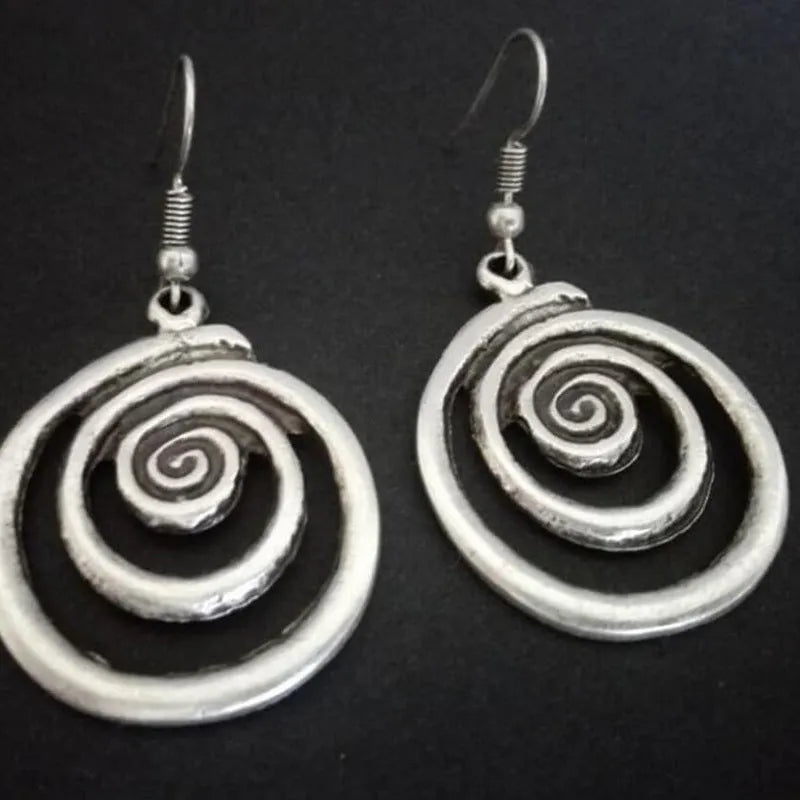 Silver geometric spiral earrings with distressed finish measuring 2.6cm by 5cm