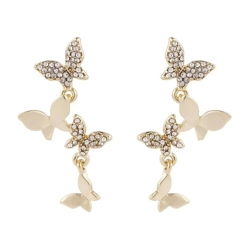 Women's gold colour copper butterfly drop earrings showing four hinged elements