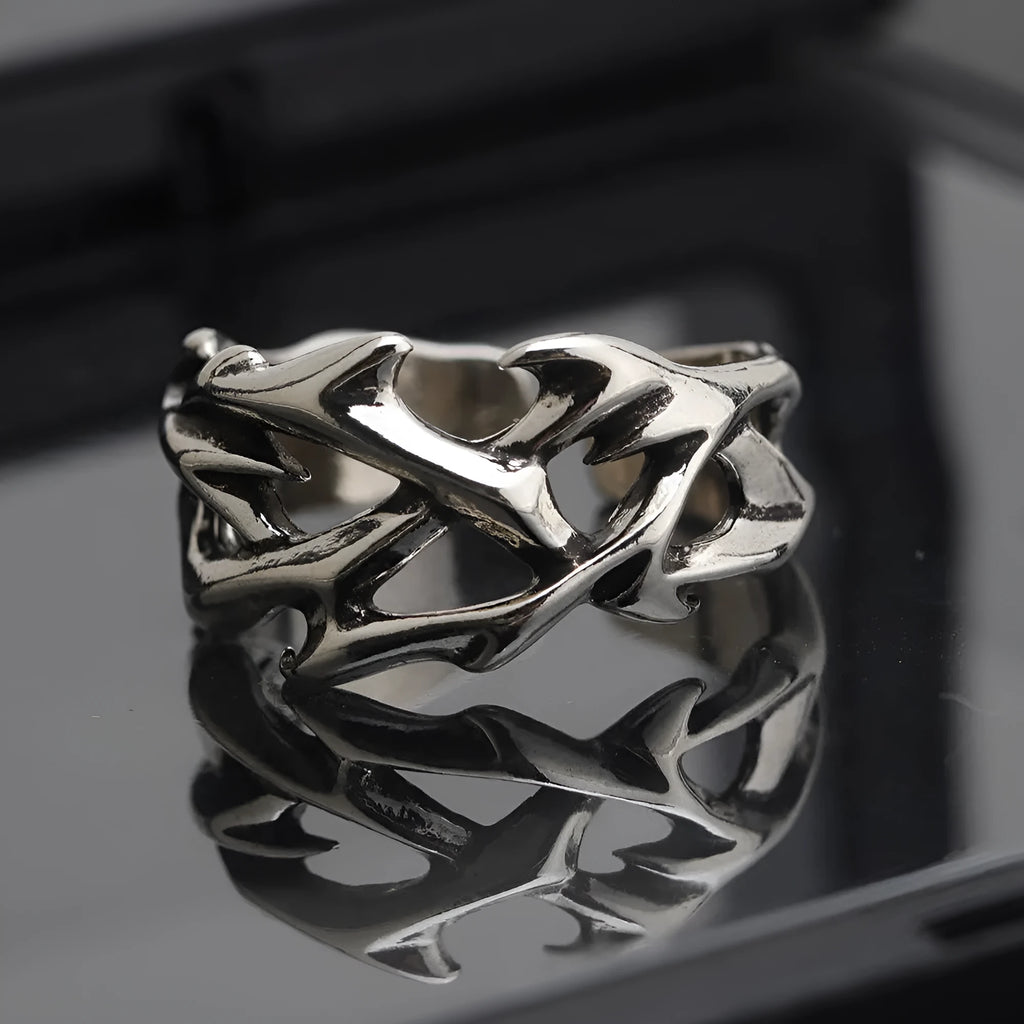 Copper geometric thorn flower ring with adjustable band on a finger, J2150 colour.