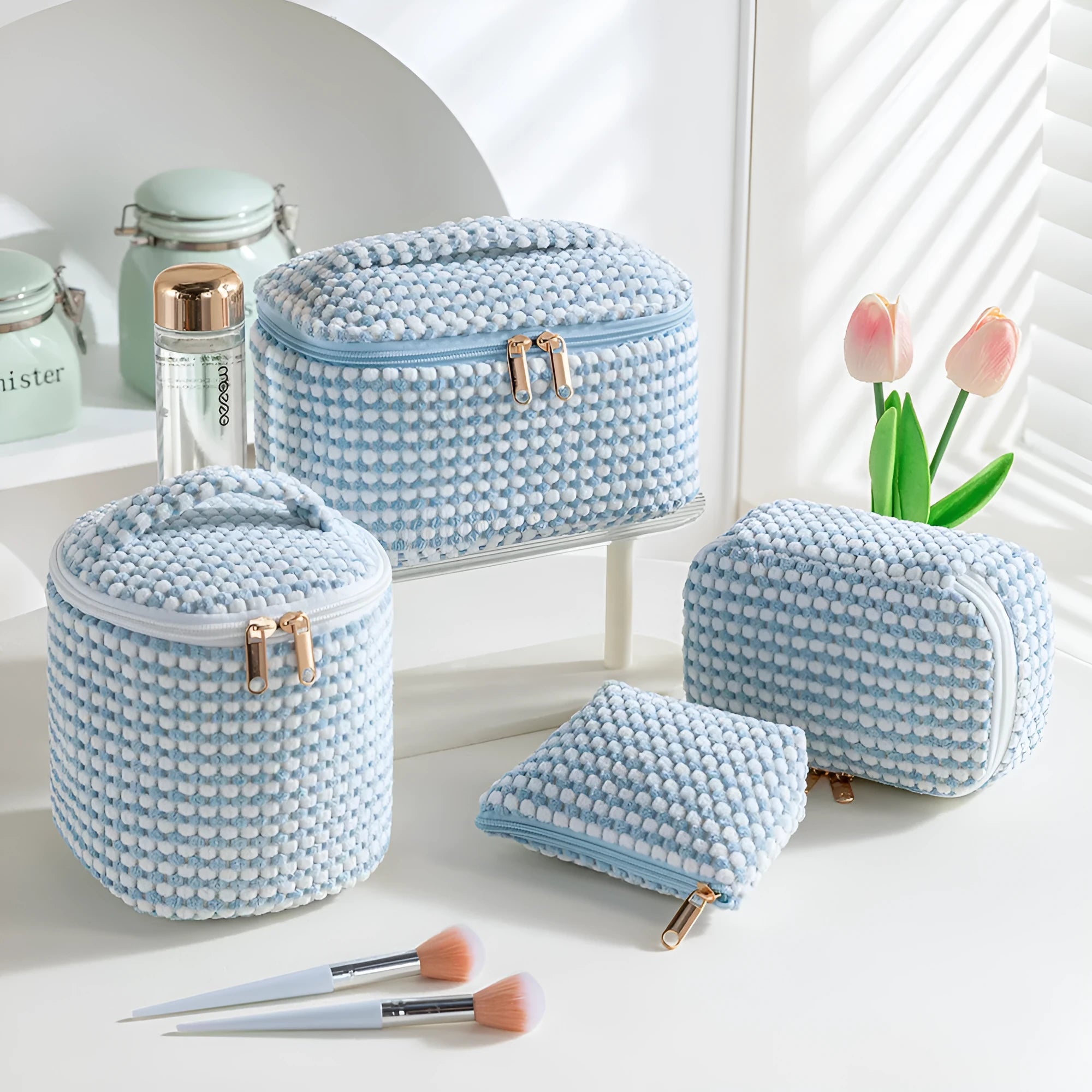 Four cube-style flannelette makeup bags in a set, shown in blue with dots colour option.