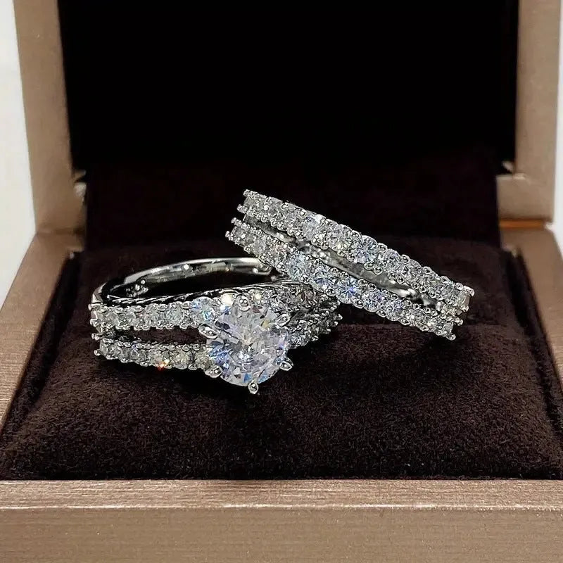 Two geometric women's rings with fully jewelled bands and round cut accents, shown in gold, rose gold, and silver colour options.