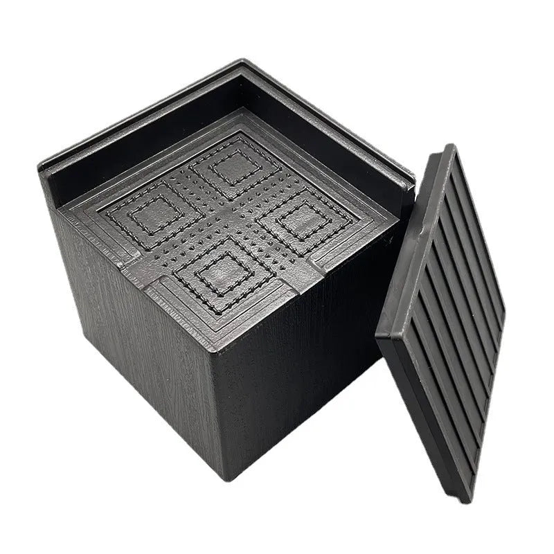 Four black thickened plastic furniture foot mats for height increase and stabilisation