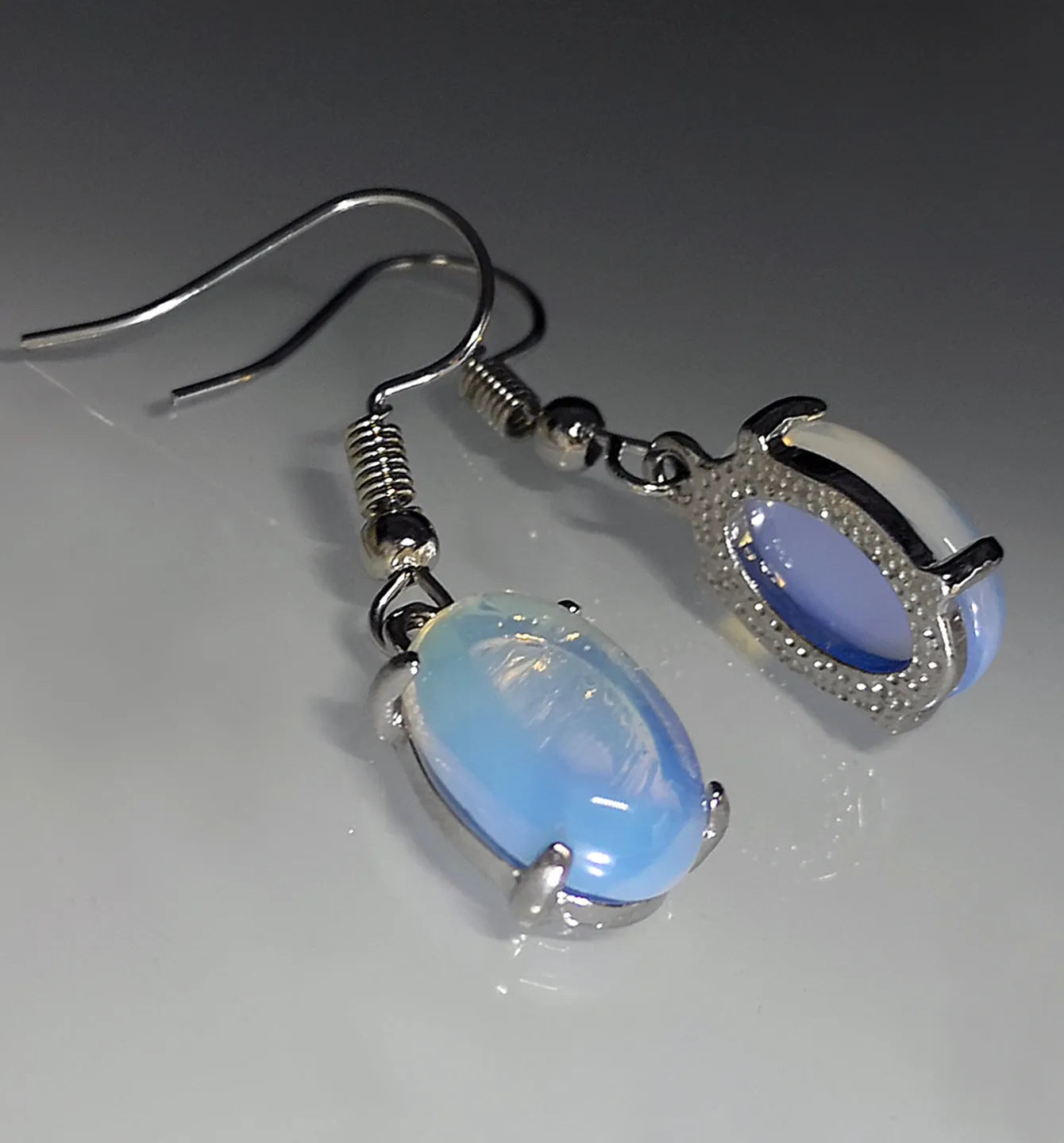 Moonlight white opal earrings with electroplated alloy drop shape design and ellipse silhouette elements