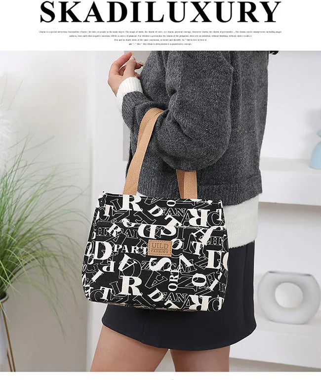 Women's printed canvas handbag with aluminium frame in square horizontal design showing floral pattern