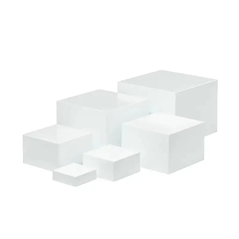 White plastic dessert table display stand with six cube-shaped racks for cakes and pastries.