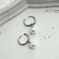 Women's geometric alloy earrings with a round pearl centre and titanium steel post.