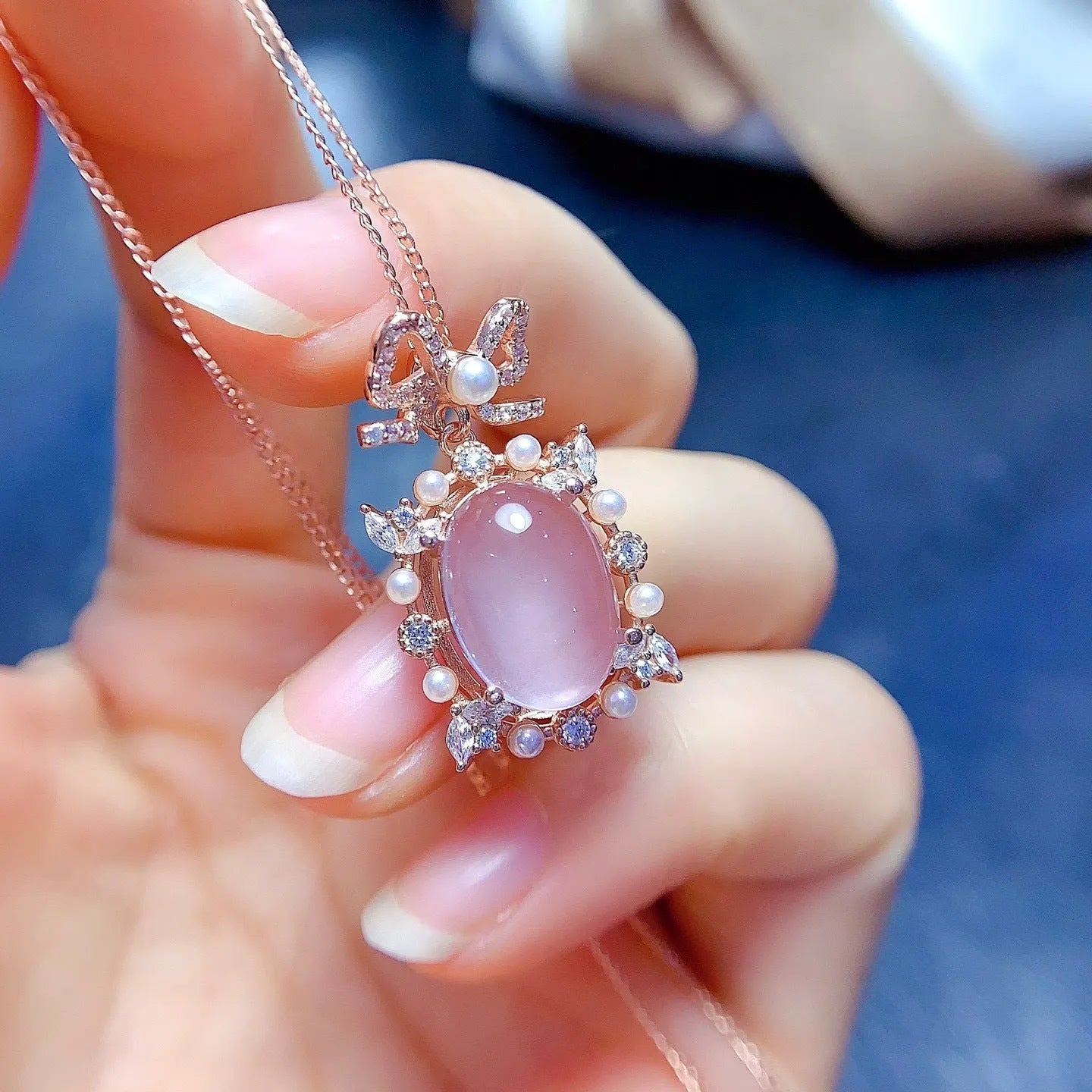 Rose gold plated geometric silver necklace with a pink rose quartz crystal pendant.