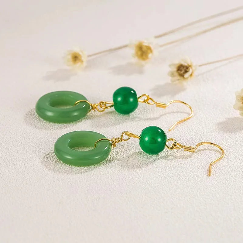 A pair of green geometric peace buckle earrings with a Chinese jade design, made from zinc alloy.