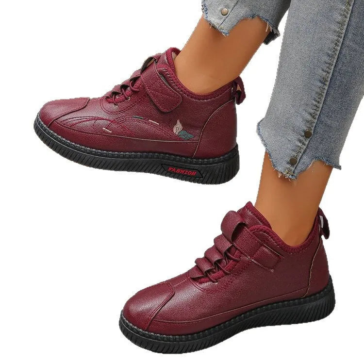 Women's black velvet house shoes with a hollow-out design and non-slip rubber sole.