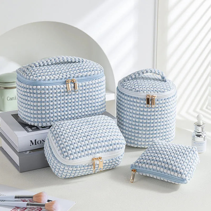 Four cube-style flannelette makeup bags in a set, shown in blue with dots colour option.