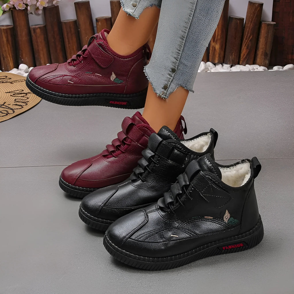 Women's black velvet house shoes with a hollow-out design and non-slip rubber sole.