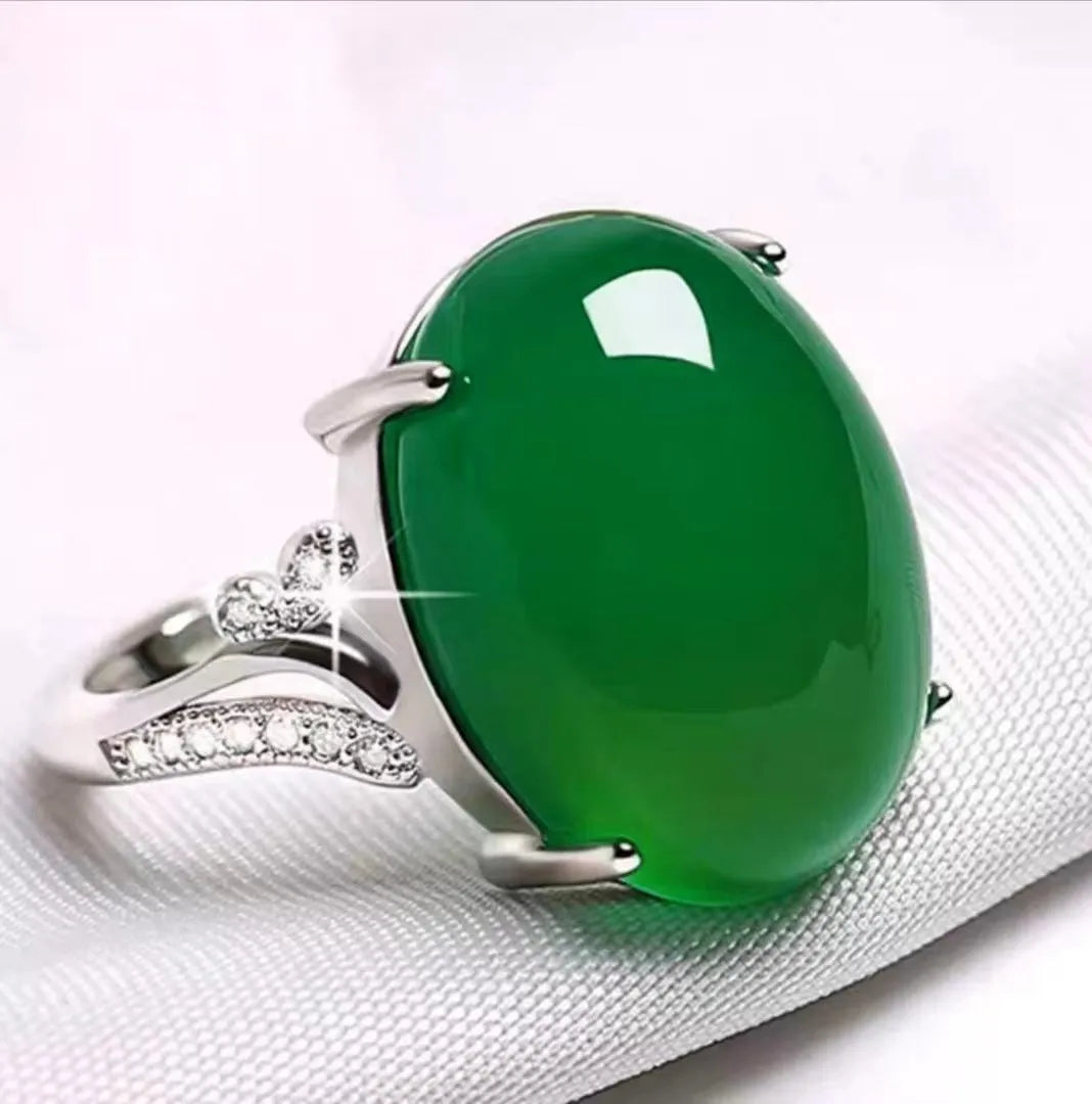 Geometric ethnic style adjustable alloy ring in one of five colours on a plain background.