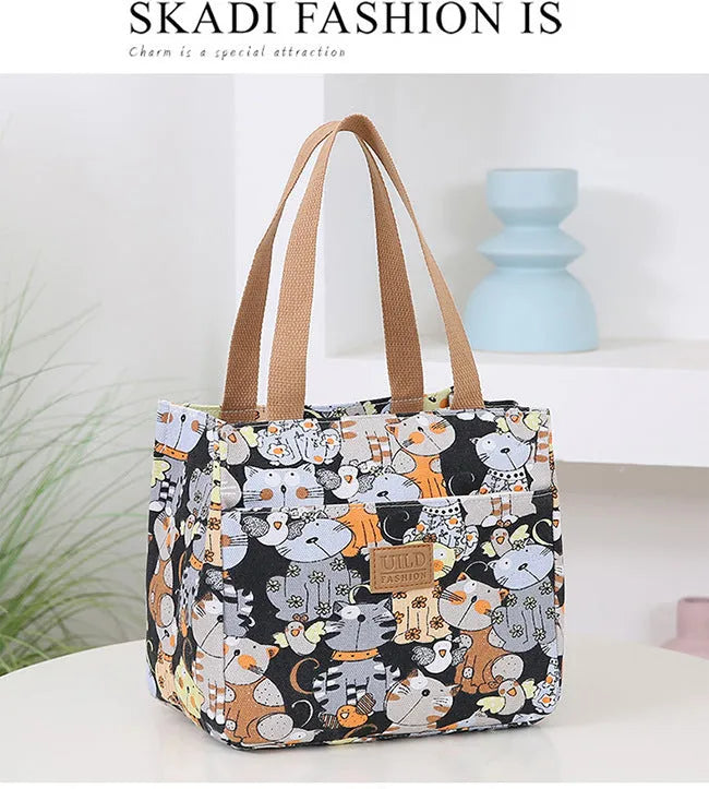 Women's printed canvas handbag with aluminium frame in square horizontal design showing floral pattern