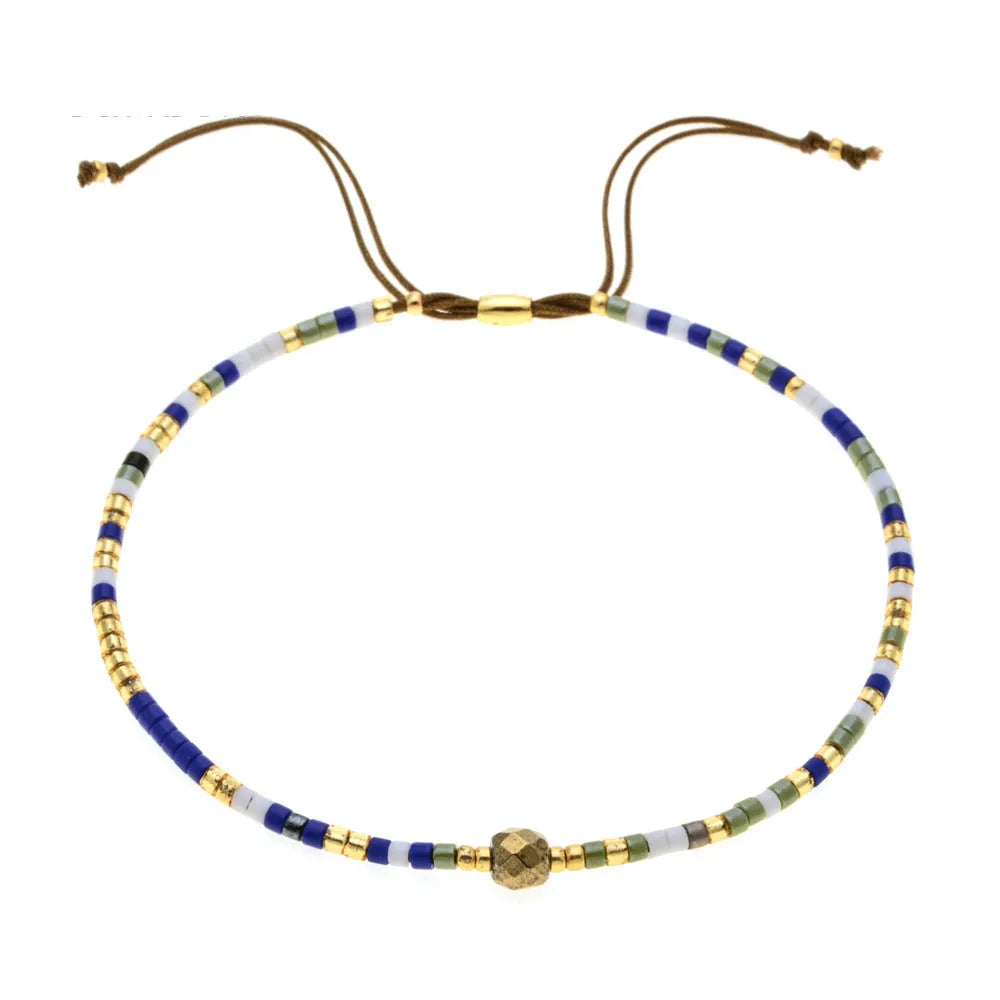 Handmade bohemian bracelet with colourful geometric glass beads on a female wrist.