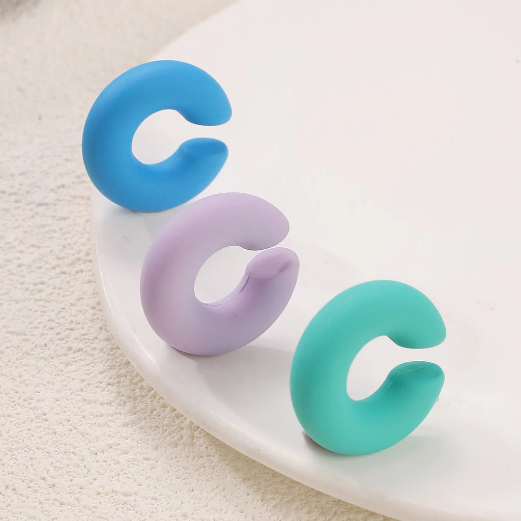 Matte coarse round C-shaped clip-on earrings in a selection of candy colours for women, no piercing required.