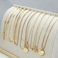 Gold-coloured women's necklace set showing ten pieces with simple alloy pendants on snake bone chains