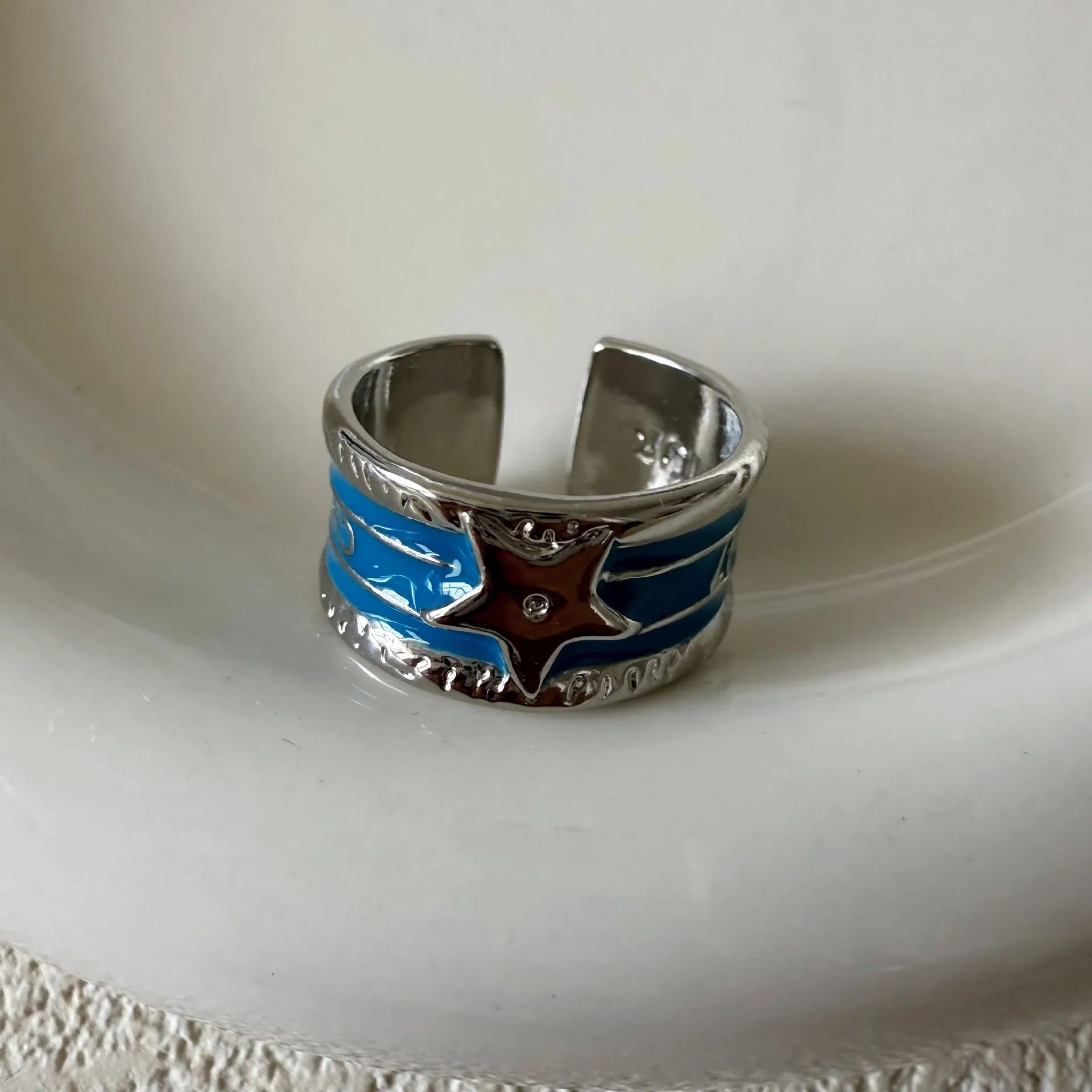 Adjustable copper ring with XINGX drop oil geometric design and distressed retro finish.