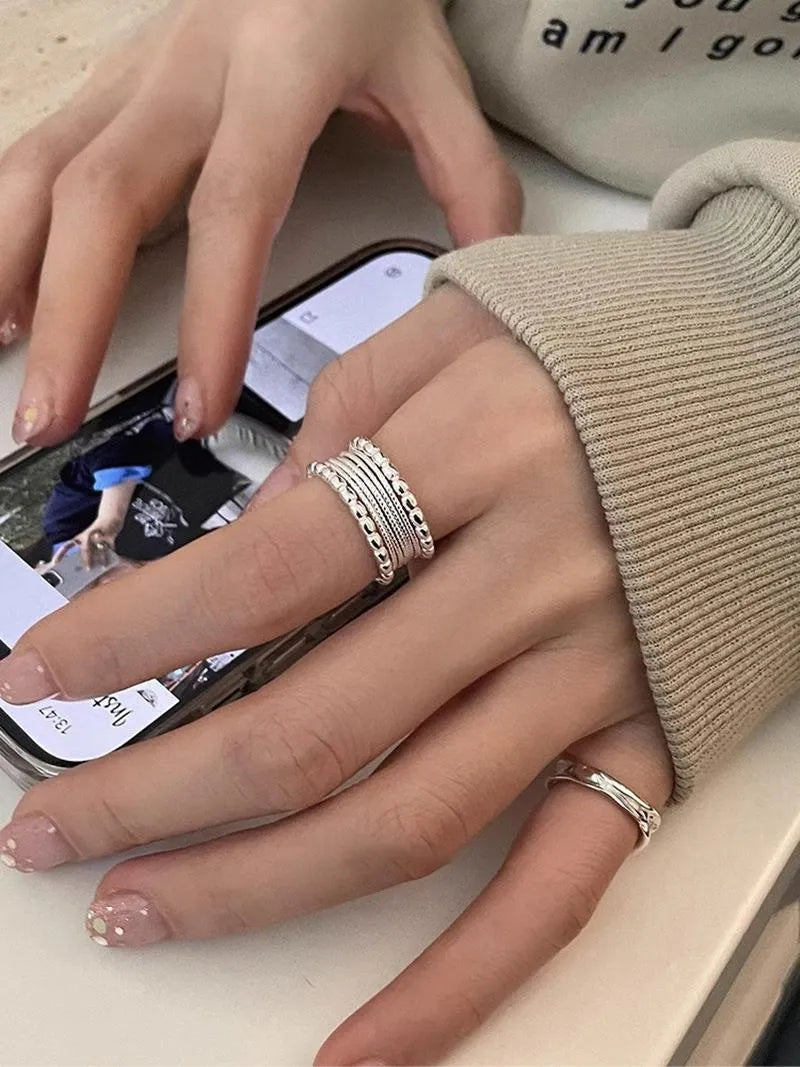 Geometric women's copper alloy ring with woven twisted design and adjustable opening