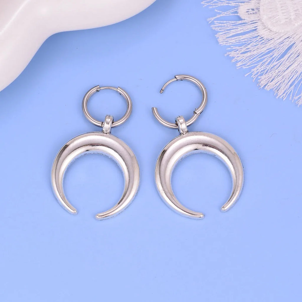 Silver alloy big hoop earrings with a gothic moon design and ear clip back.