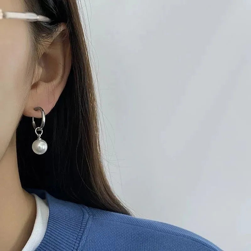 Women's geometric alloy earrings with a round pearl centre and titanium steel post.