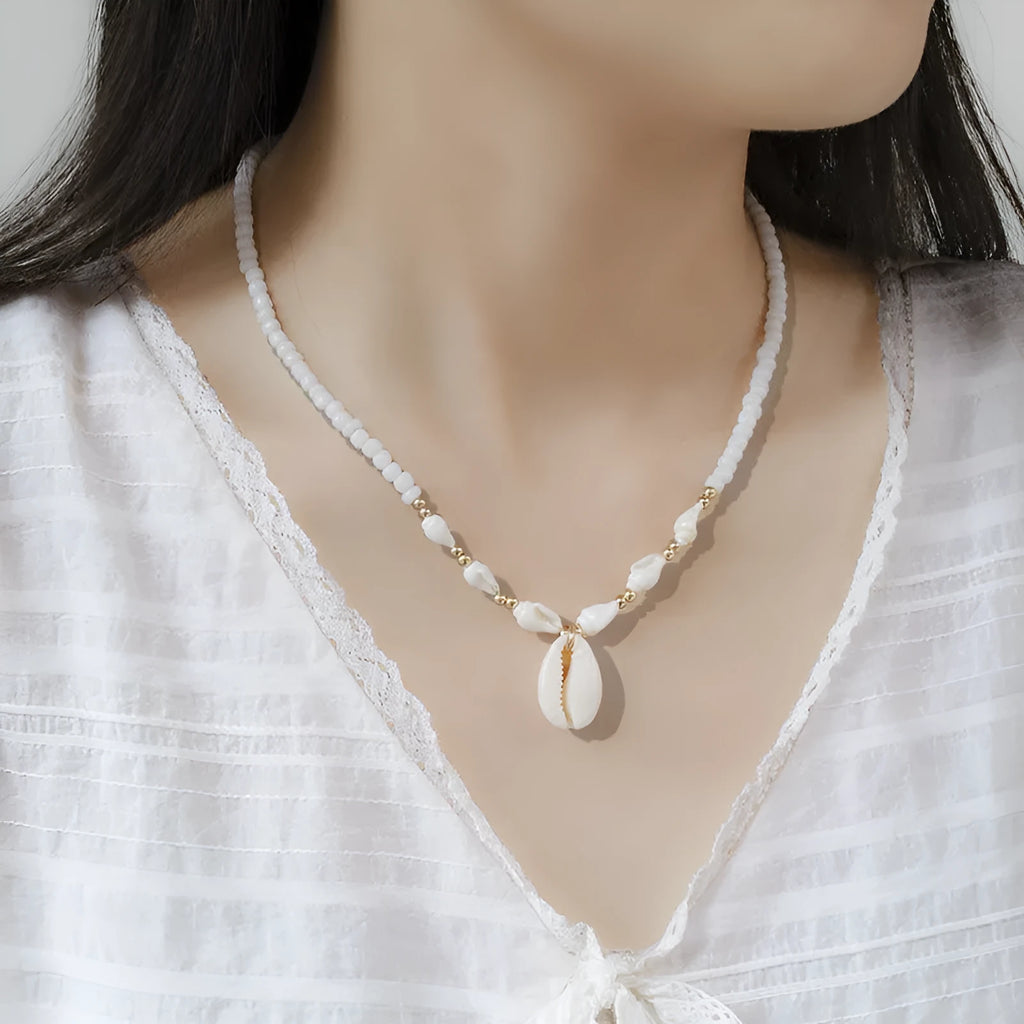 White conch shell pendant and bead necklace on a regular chain.