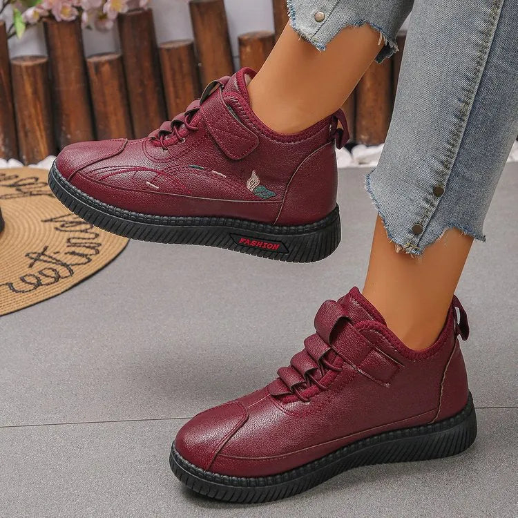 Women's black velvet house shoes with a hollow-out design and non-slip rubber sole.