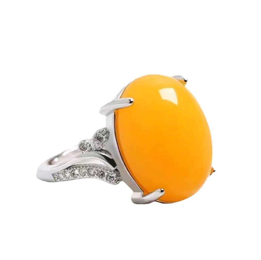 Geometric ethnic style adjustable alloy ring in one of five colours on a plain background.