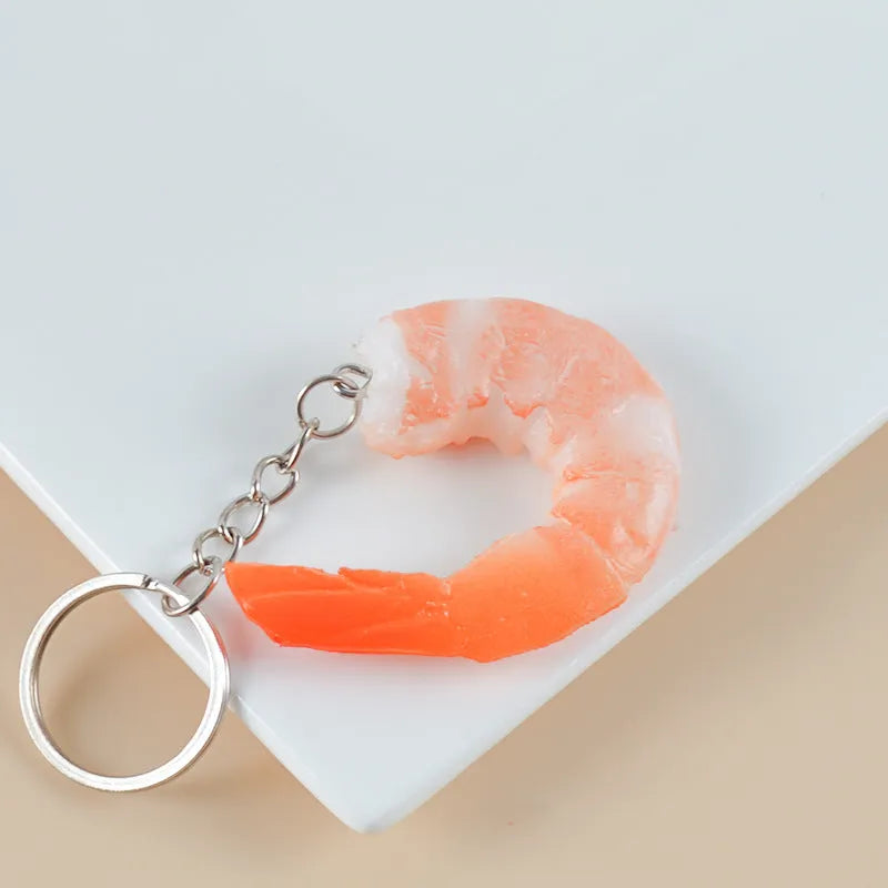 PVC injection moulded shrimp-shaped keychain with modern minimalist design