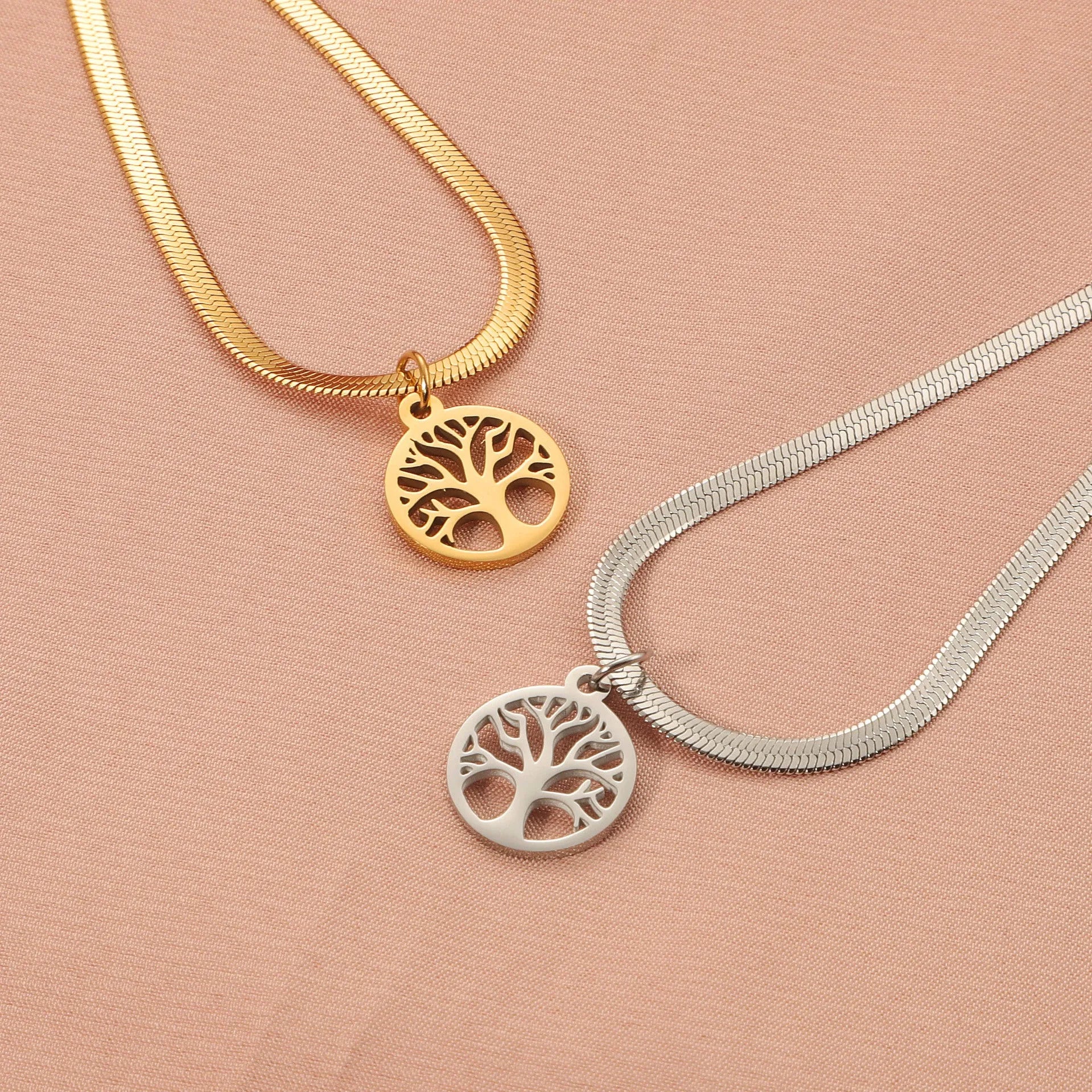 Stainless steel necklace with tree pendant on snake bone chain in gold or steel colour.