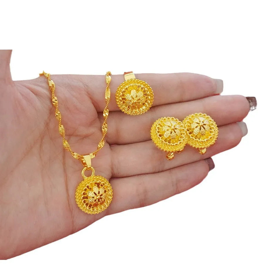 Three-piece gold-plated floral jewellery suit with necklace, earrings and ring on water wave chain