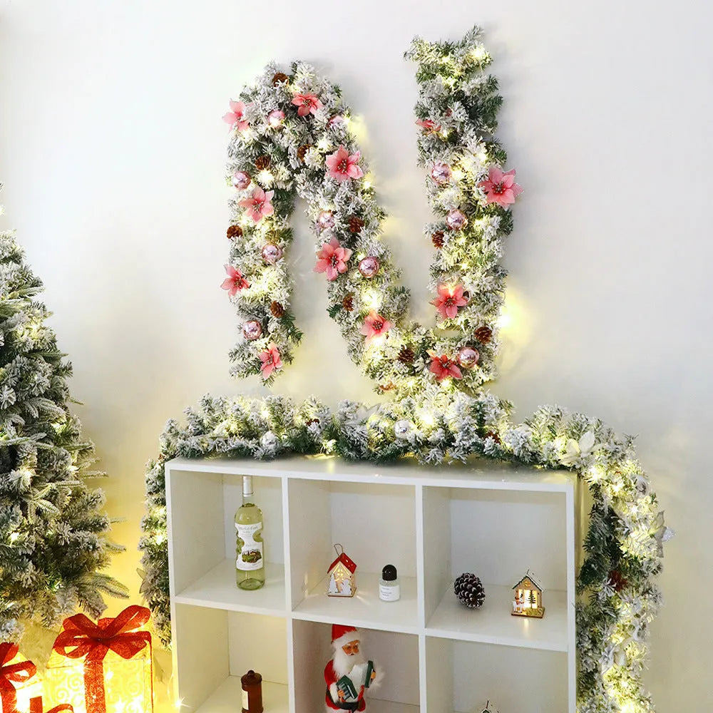 Snow-flocked Christmas rattan garland vine in red, draped on a mantelpiece.
