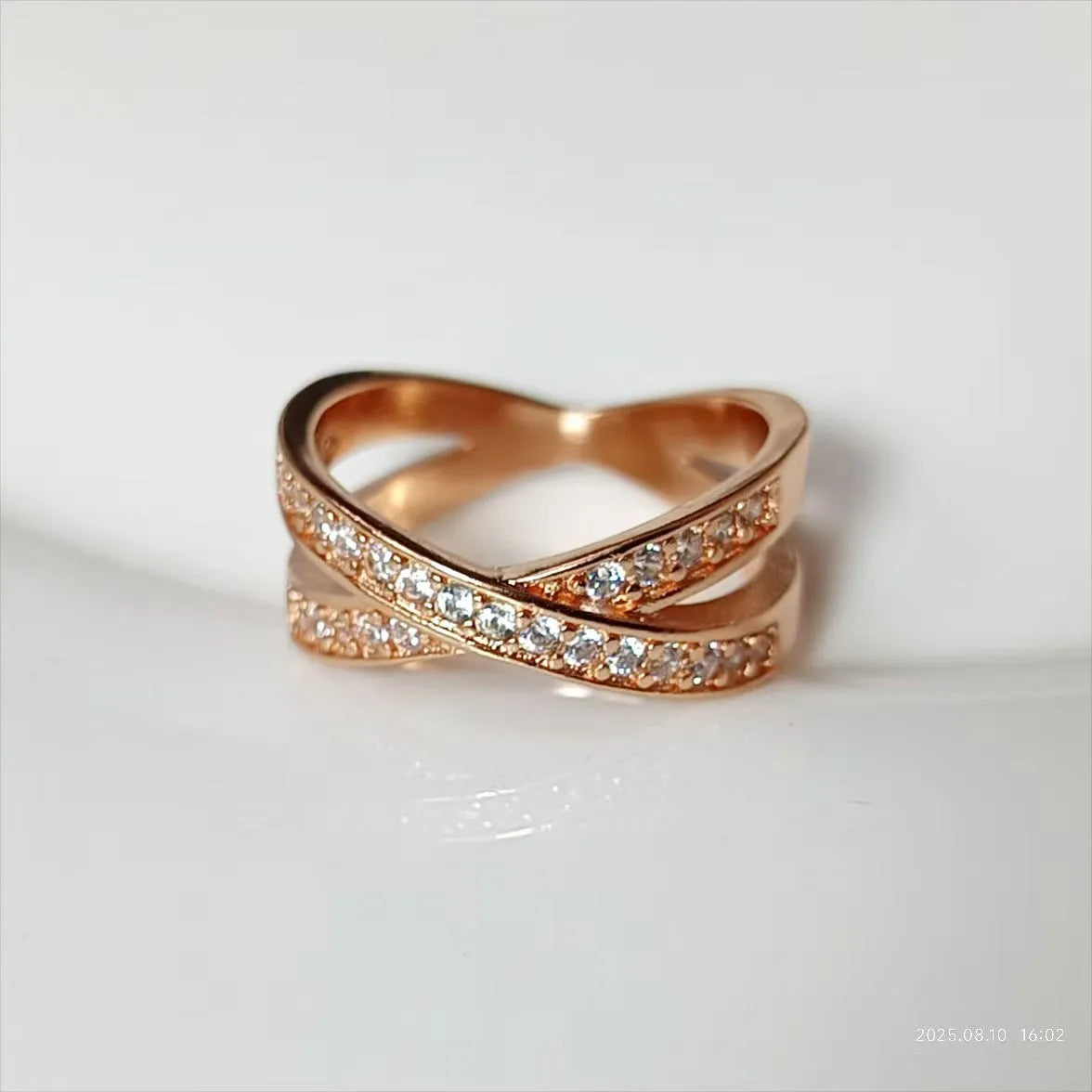 Electroplated copper cross ring with micro-inlaid zircon stones in silver finish