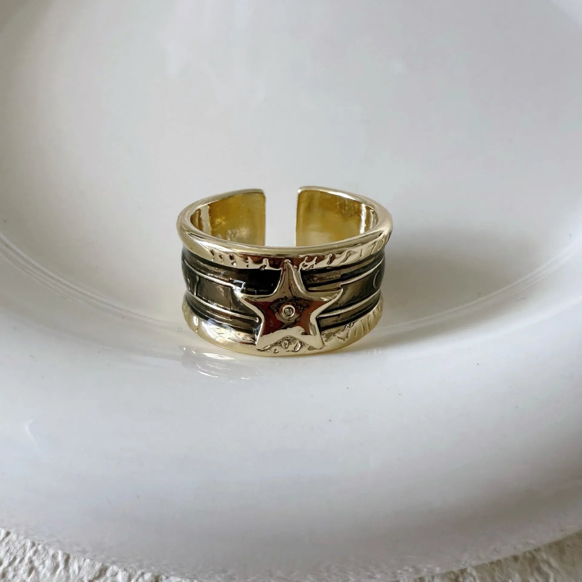 Adjustable copper ring with XINGX drop oil geometric design and distressed retro finish.