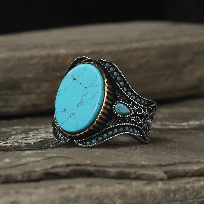 Men's antique silver alloy ring with a round design and central turquoise stone.