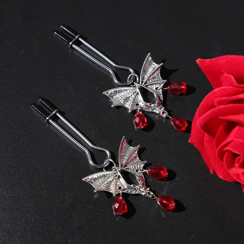 Silver alloy adjustable bat nipple clamp with ruby decorative clip for adult use.