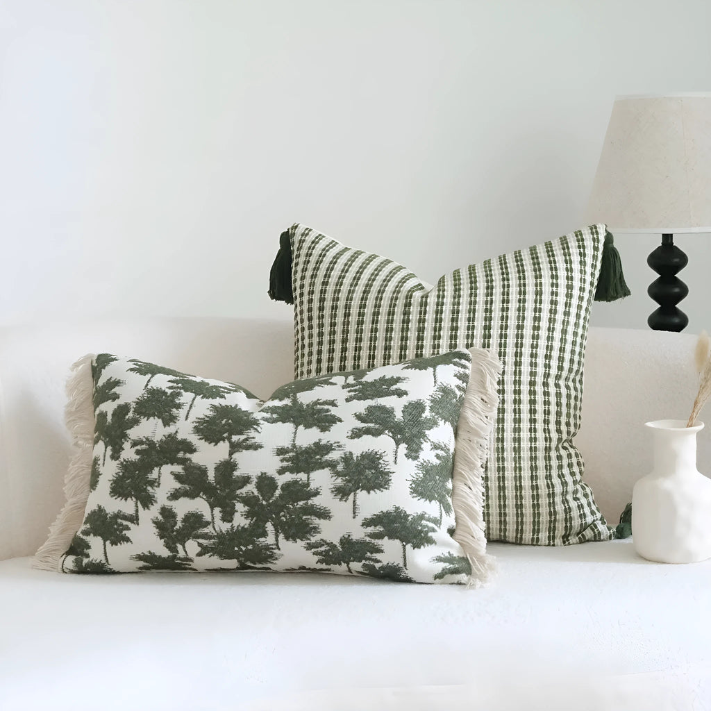 Green cotton and linen hotel sample pillow with tassel details and botanical patterns for display use