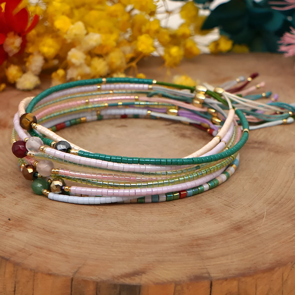 Handmade bohemian bracelet with colourful geometric glass beads on a female wrist.