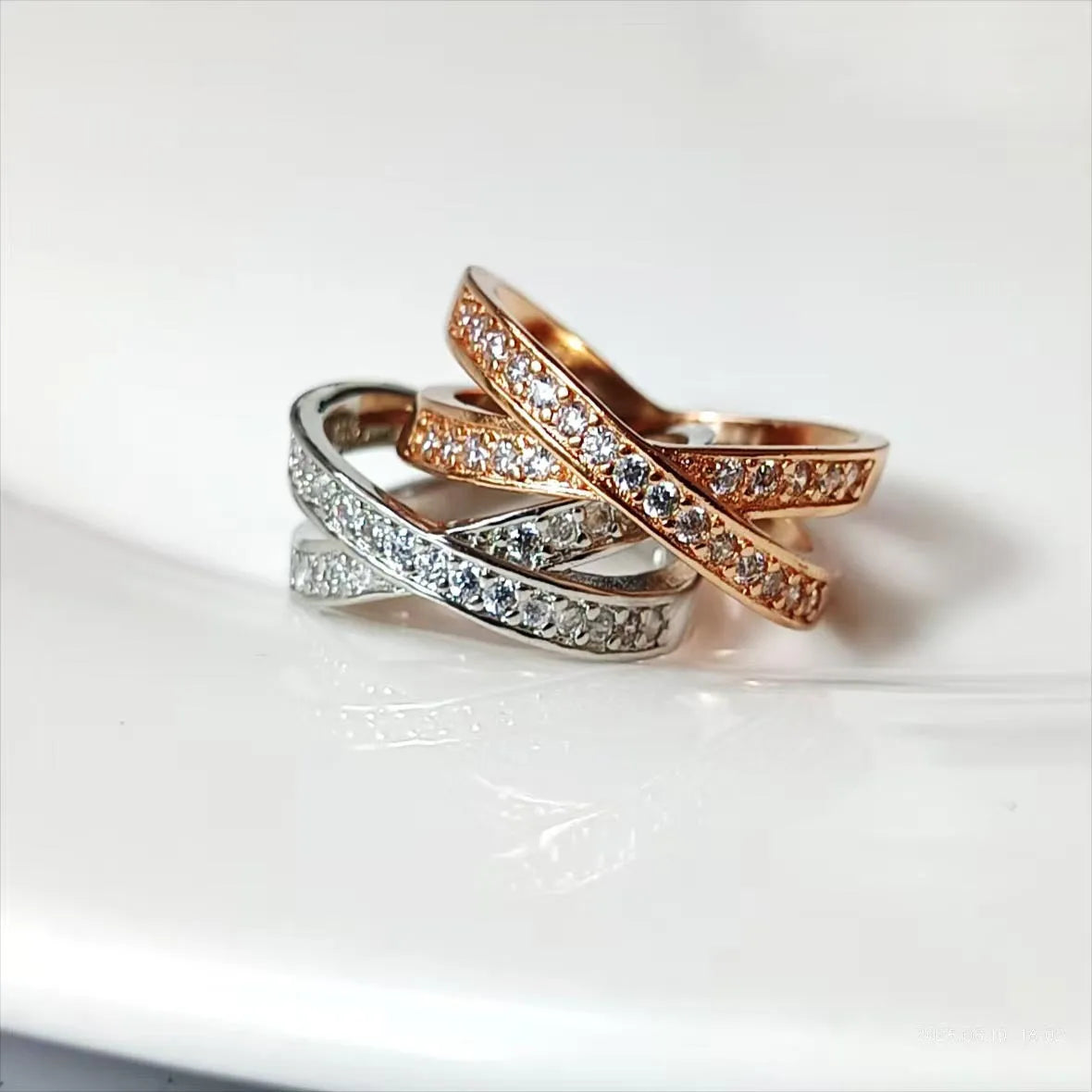 Electroplated copper cross ring with micro-inlaid zircon stones in silver finish