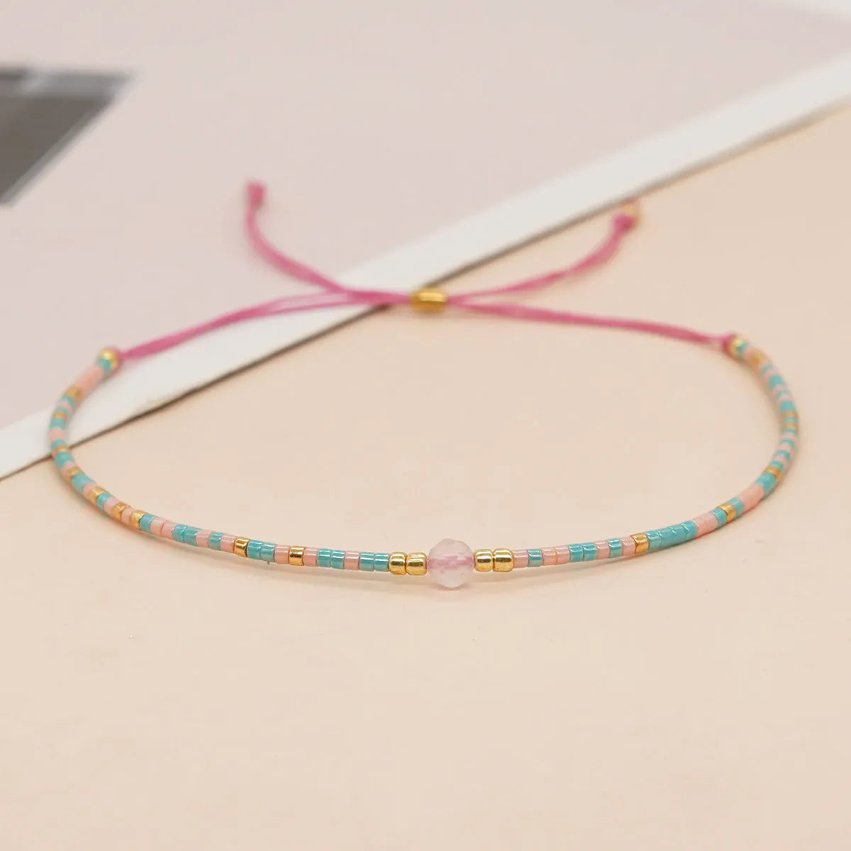 Handmade bohemian bracelet with colourful geometric glass beads on a female wrist.