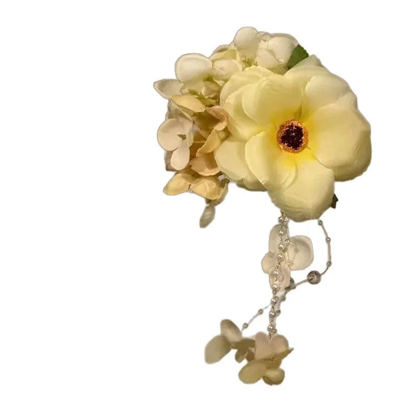 Yellow flower tassel hairpin side clip accessory on display