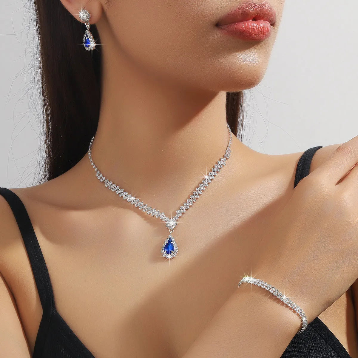 Women's claw chain necklace and earrings set with water drop rhinestones in multiple colour options