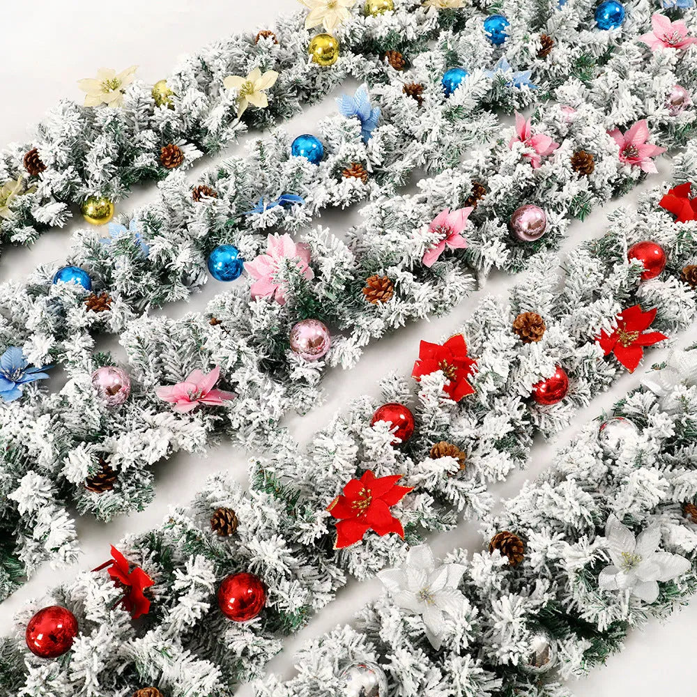 Snow-flocked Christmas rattan garland vine in red, draped on a mantelpiece.