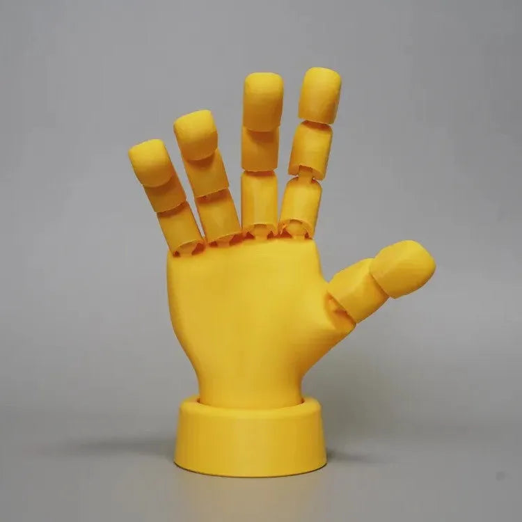 Yellow movable joint hand prop ornament made of PLA plastic on white background